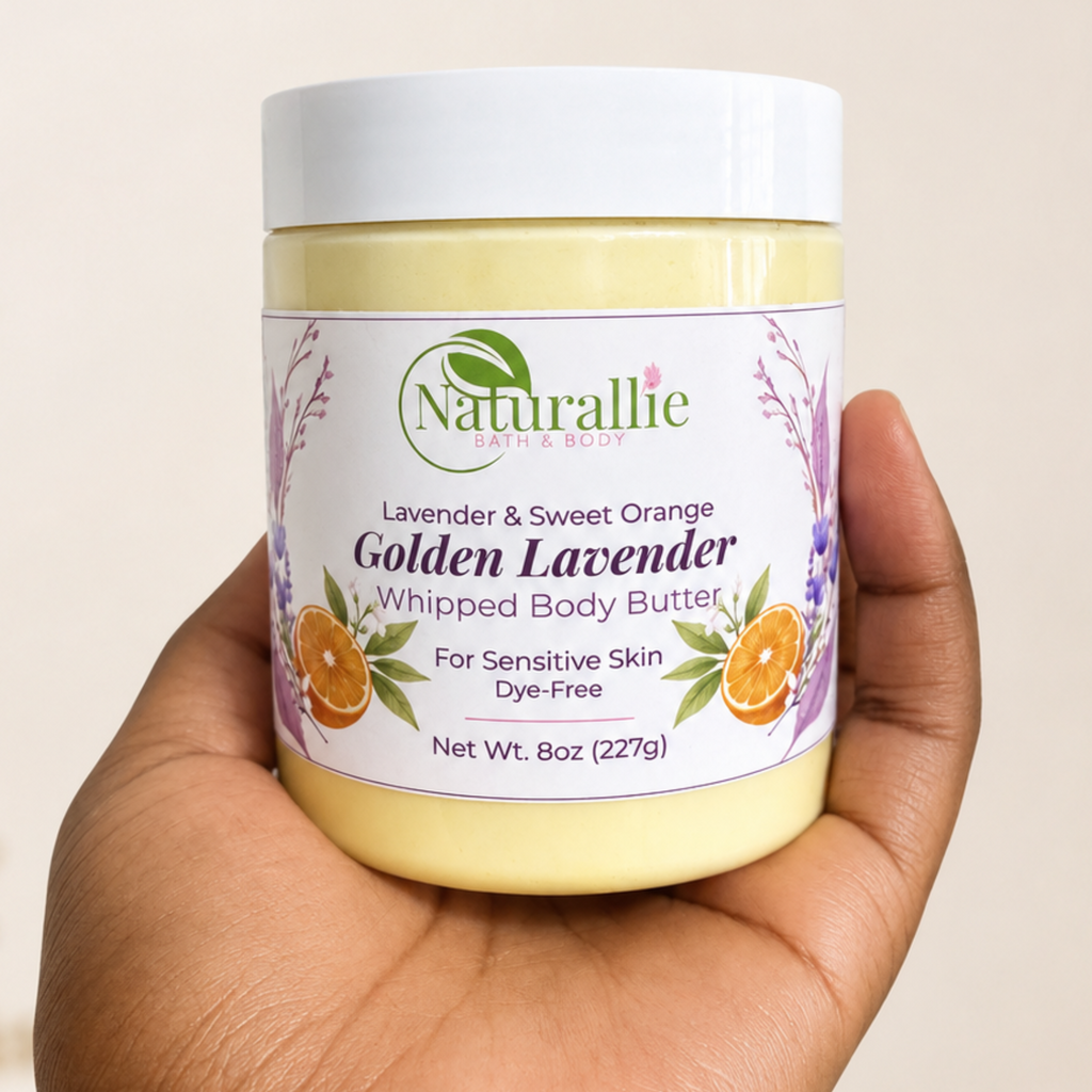 A hand holding a white jar of Naturallie Golden Lavender Whipped Body Butter against a plain beige background.